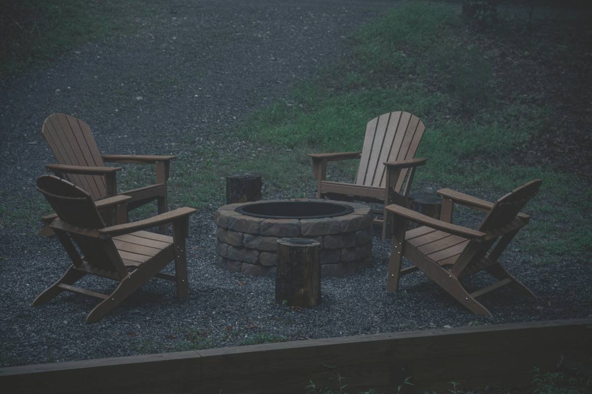 Comparison chart of common fire pit outdoor furniture materials showing heat resistance, durability, and safety ratings