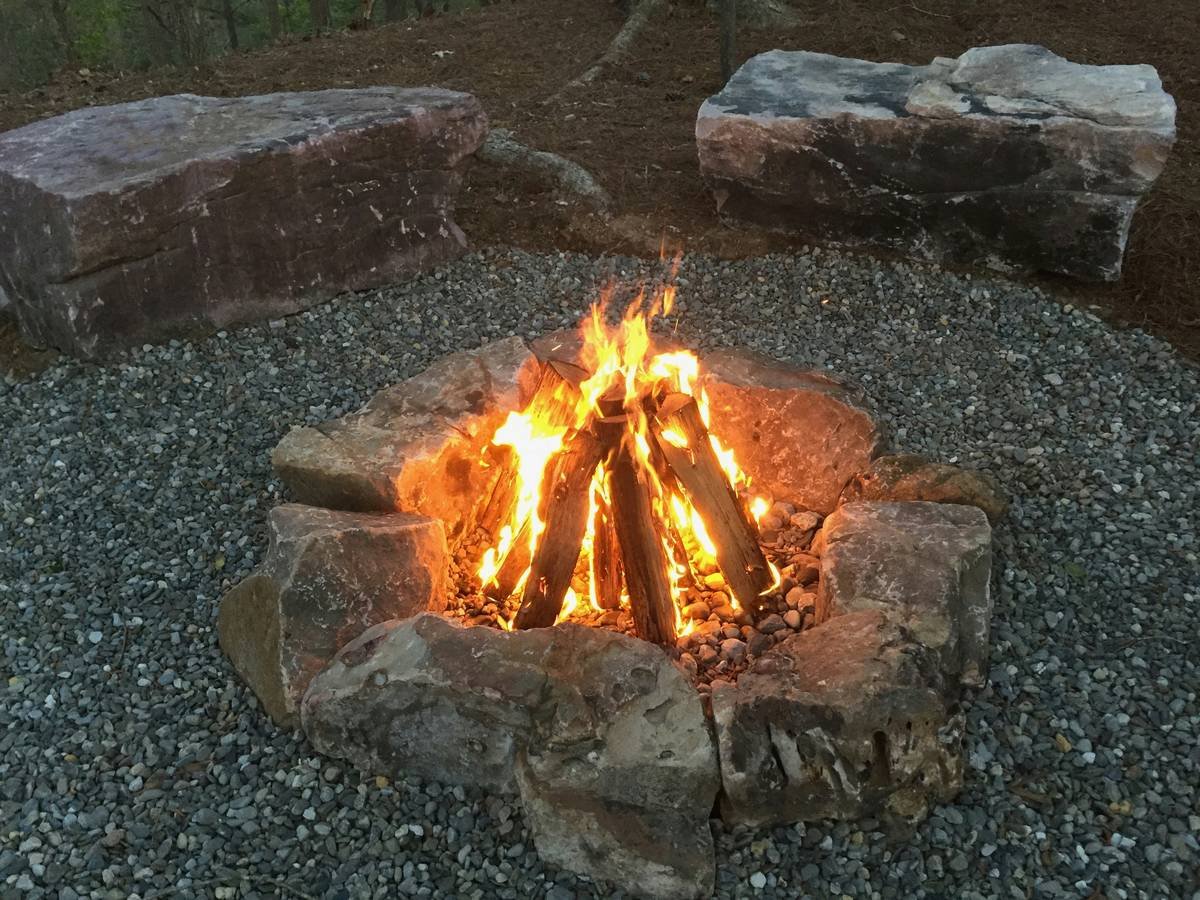 building a fire pit area with integrated bench seating and wood storage